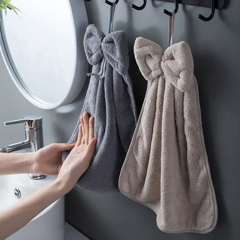 Gray and beige plush coral velvet soft hand towels with bow ties hanging on hooks for kitchen and bathroom decorbites coral velvet