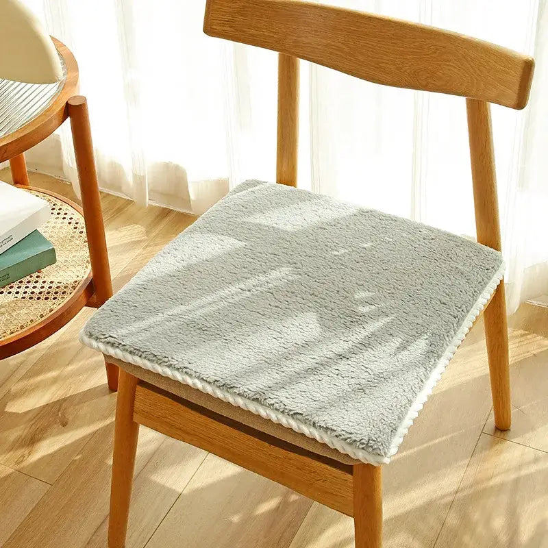 Soft gray wool chair cushion with white braided trim for dining room comfort from decorbites cozy lambs wool collection