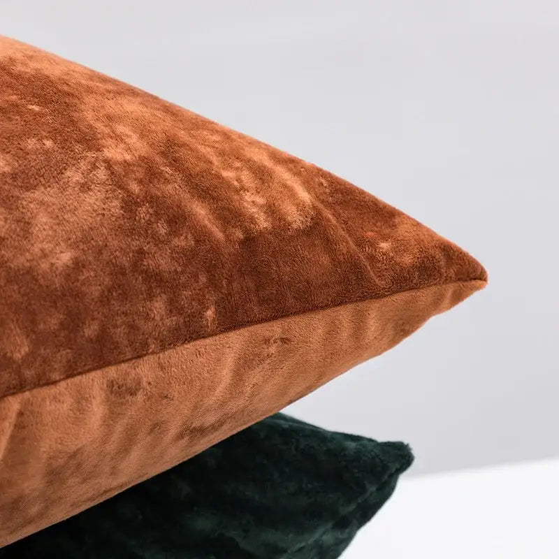 Plush dark grain velvet pillow cover in rust color with soft textured surface and neatly stitched edges for living room decor