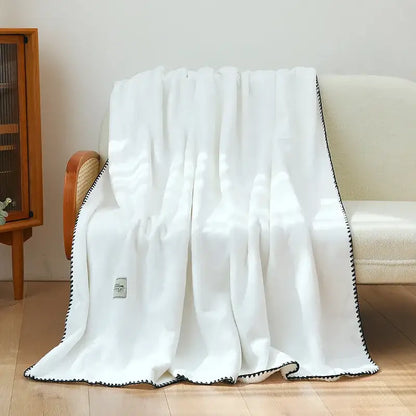 White plush double-layer warm blanket with black zigzag trim by decorbites for cozy bedroom use