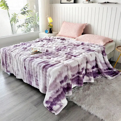A plush tie-dye purple and white fleece throw blanket with soft fluffy texture and chunky weave for living room use