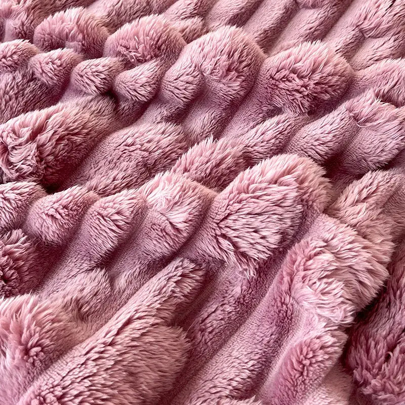 Soft pink plush bamboo velvet blanket with textured ribbed pattern and braided trim for bedroom throw