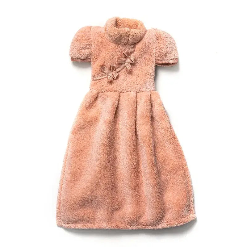 A soft peach coral fleece cheongsam hand towel with short puffy sleeves and bow details for kitchen and bathroom decorbites