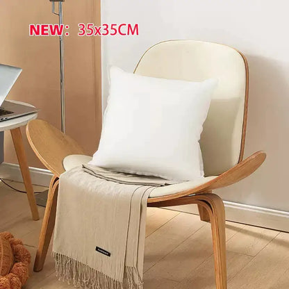 White square plush decorbites cotton-padded pillow core resting on wooden chair for living room cushion insert