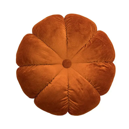 A rust-colored velvet pumpkin-shaped cushion with quilted petals and a button center for home decor and decorbites 3d flowers pillows