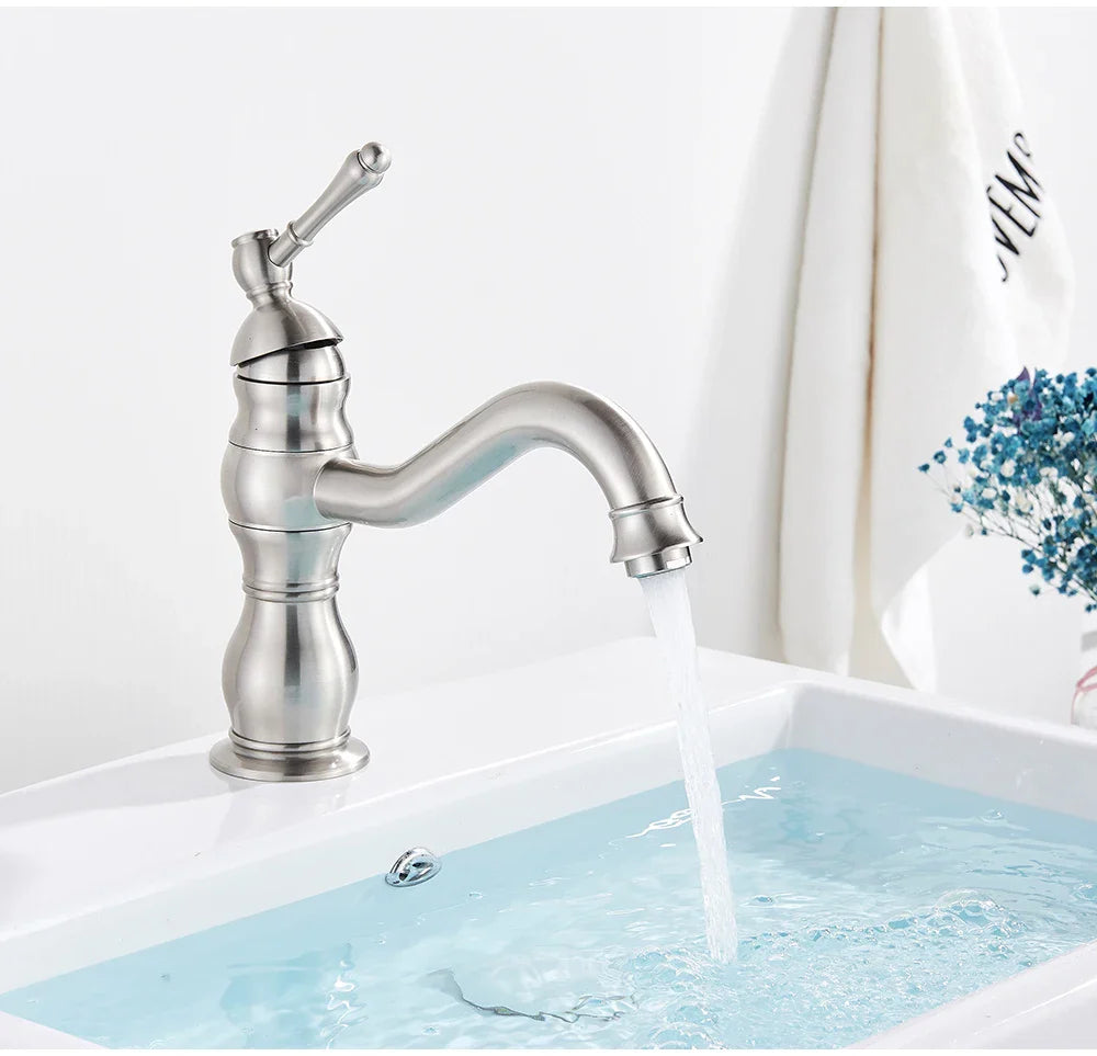 Stylish deck mounted single hole bathroom faucet with brushed nickel curved spout and decorative ridged base housing material
