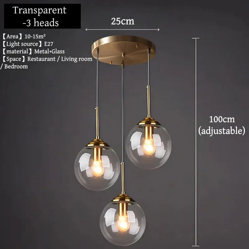 Brass-finished glass pendant light trio with clear globe shades and adjustable height for dining room use