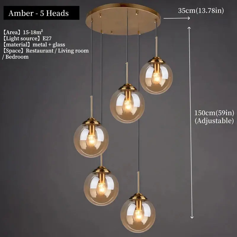 Polished steel glass pendant light with gold-toned metal and smoked glass spheres ideal for dining room lighting