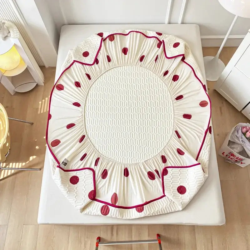 Cream-colored bed skirt with red polka dots and quilted center complements the polka dot smile cool comforter set