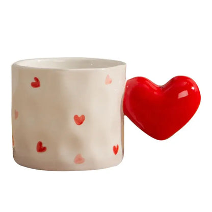 White ceramic heart design mug with red and pink heart decals and a glossy red heart-shaped handle decorbites heart design