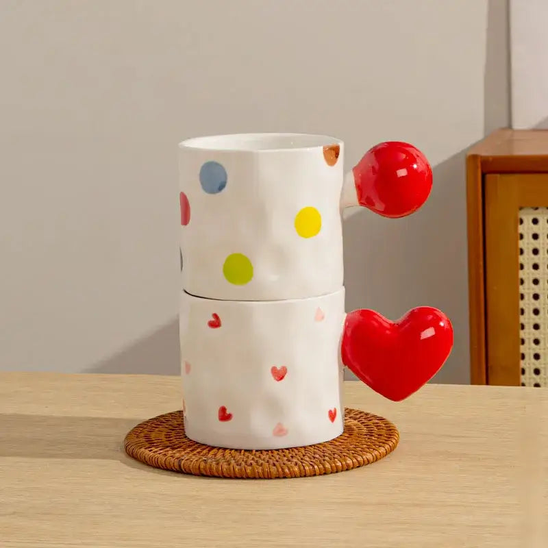 Two white ceramic mugs with colorful polka dots and decorbites heart design glossy red handles ideal kitchen cups