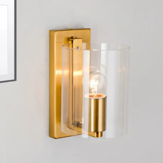 Post modern brass wall sconce with gold tone, clear textured white cylindrical glass shade, and exposed bulb for bedroom lighting 110v-120v 220v-240v