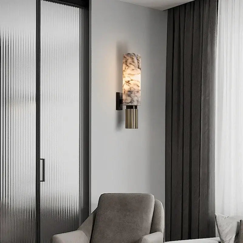 Post-modern brushed brass copper alabaster wall lamp featuring a cylindrical marble-patterned glass shade for bedroom decor