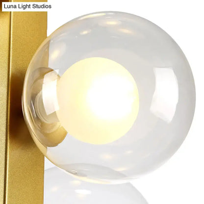 Decorbites gold finish chandelier with translucent glass orb shade and glowing light bulbs for post modern dining room