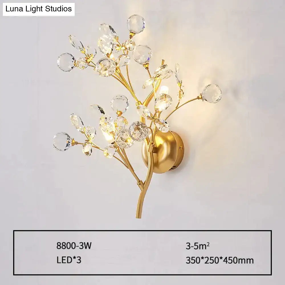 Post modern luxury gold-toned wall sconce with crystal branches and spherical accents for modern luxury branch decor