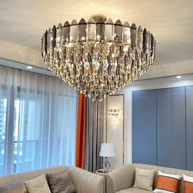 A luxurious decorbites crystal chandelier with gold-toned center and cascading clear faceted crystals for living room