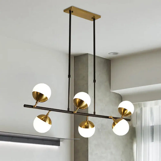 Postmodern black and gold island ceiling light with five white glass shades on polished brass fixtures for kitchen island