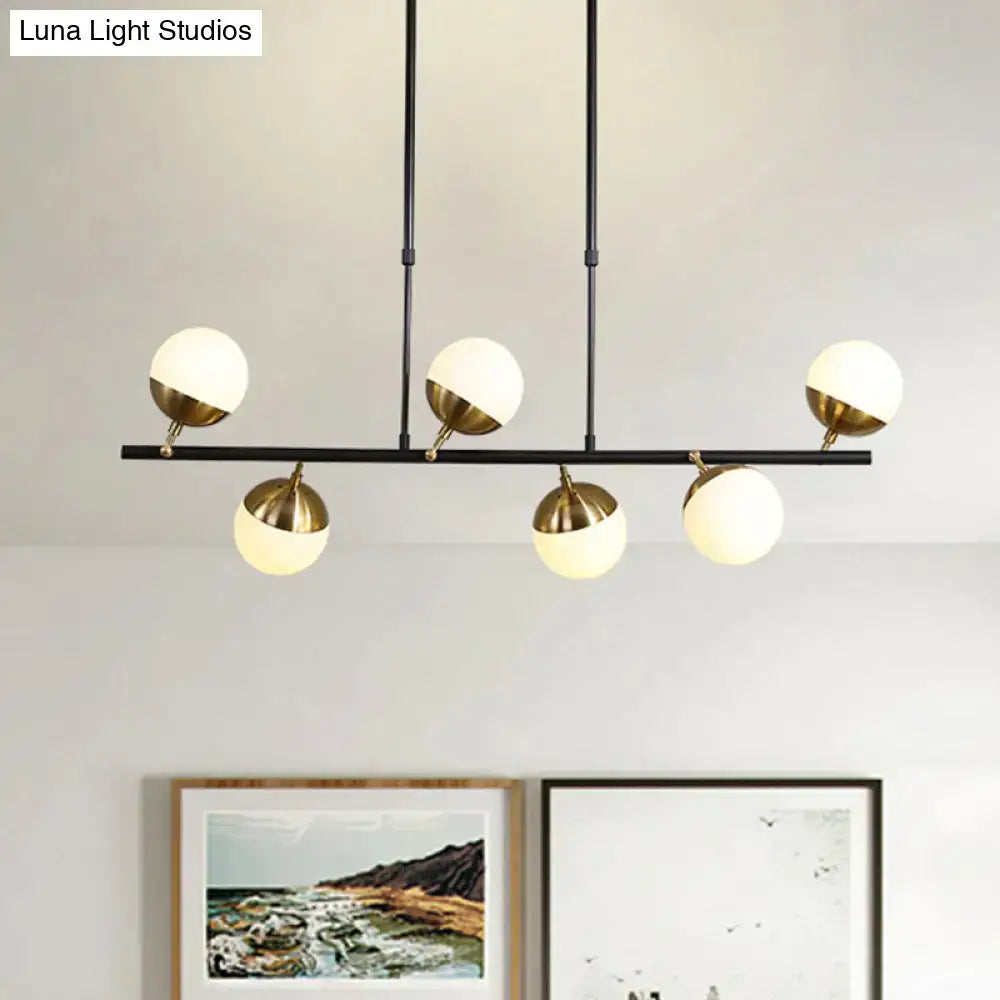 Postmodern black and gold island ceiling light with five spherical glass globes and brass-colored metal bases
