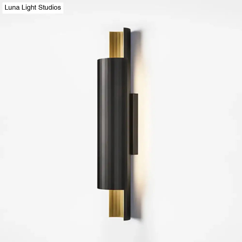 Modern black and gold pipe shaped led wall mount with sleek cylindrical design for bedroom lighting