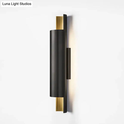 Modern black and gold pipe shaped led wall mount with sleek cylindrical design for bedroom lighting