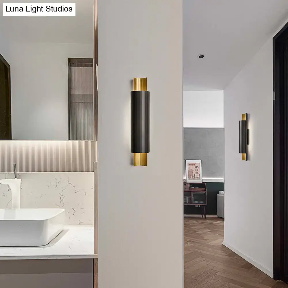 Postmodern black and gold pipe shaped led wall mount with sleek cylindrical body and polished trim for bedroom light