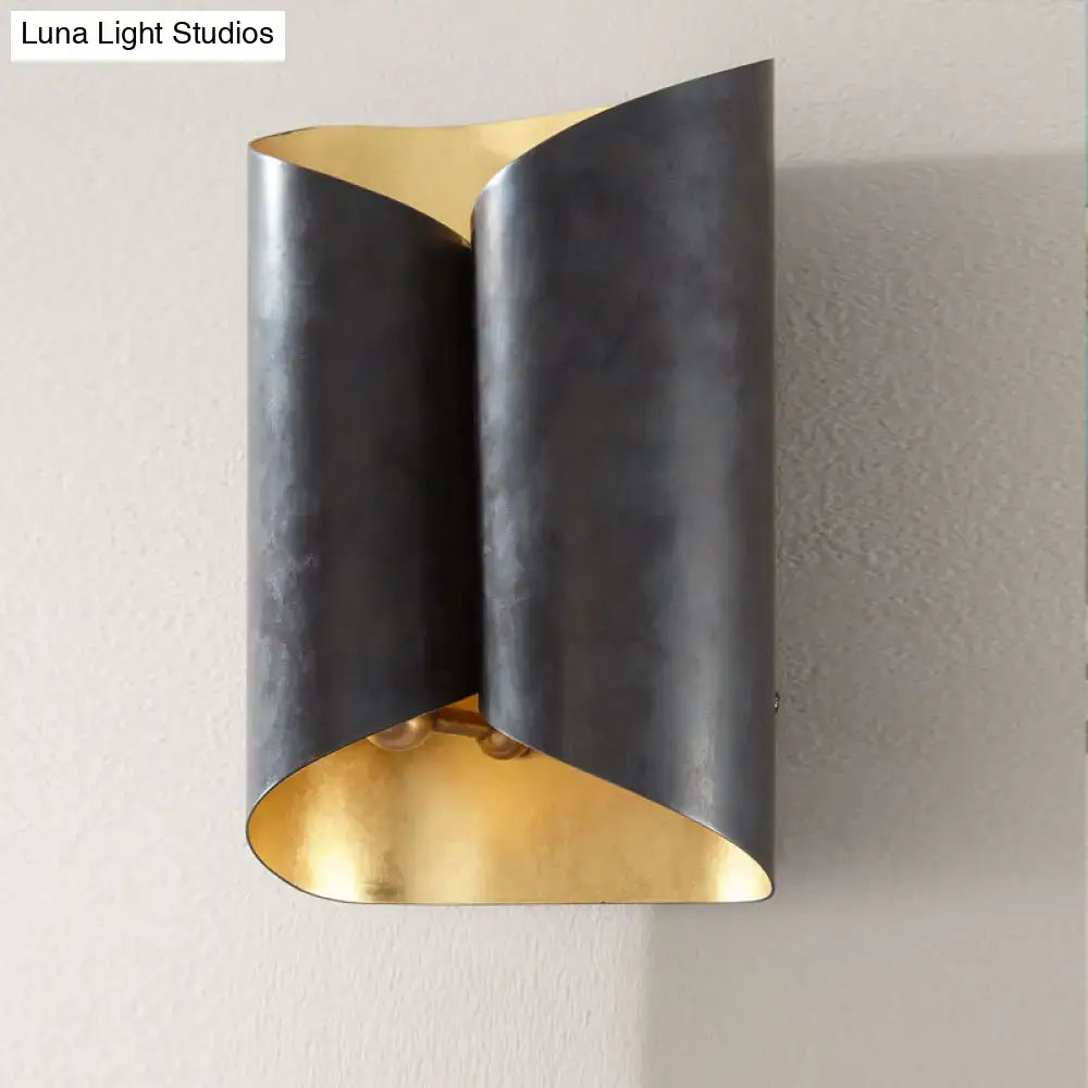 Modern postmodern wall lamp with sleek curved black metal body and contrasting gold interior for stairwell sconce use