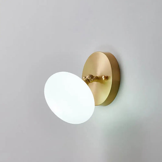 Postmodern brass and glass wall sconce with frosted white glass shade and bulb included for bedroom lighting type