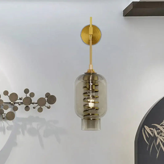 Postmodern brass wall lamp with smoke gray glass shade and gold metal stem for tea room lighting