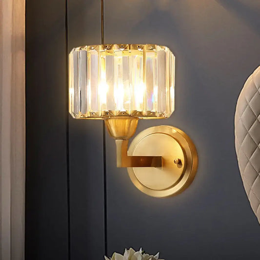 Postmodern gold-toned wall lamp with faceted crystal prism shade and brass fixture height for bedroom sconce lighting