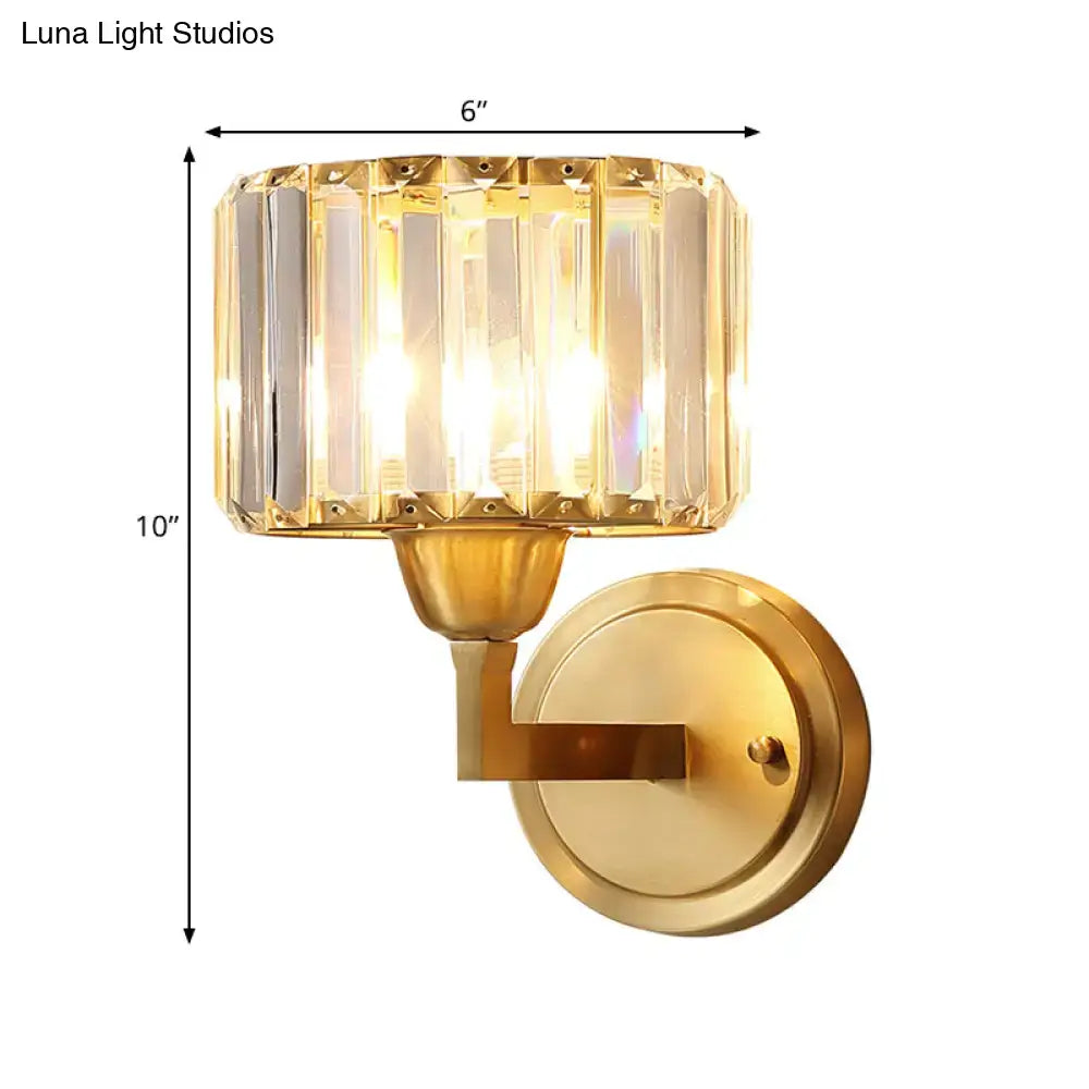 Gold-finished postmodern wall lamp with cylindrical crystal prism shade and vertical facets featuring fixture height detail
