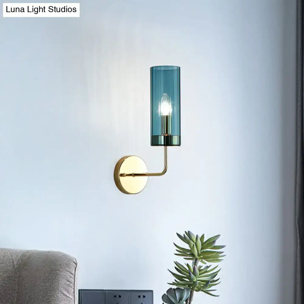A sleek brass finish wall lamp with a cylindrical teal glass shade and e12 e14 base for bedroom sconces