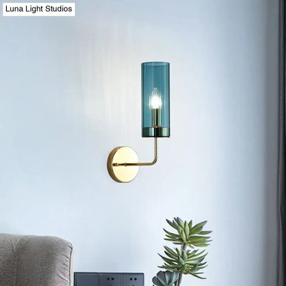 A sleek brass finish wall lamp with a cylindrical teal glass shade and e12 e14 base for bedroom sconces