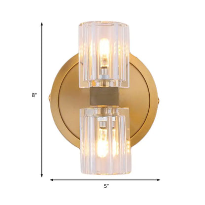 Gold-toned postmodern brass finish wall light with two faceted glass shades and central square metal accent fixture height
