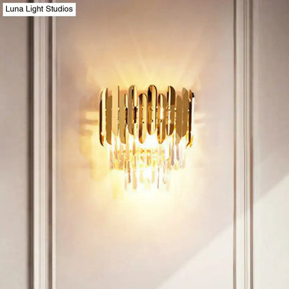Postmodern brass tiered flush wall sconce with gold-toned vertical bars and crystal droplets for bedroom lighting