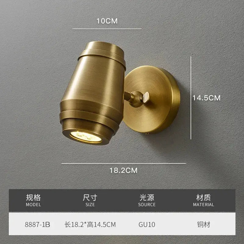 Postmodern brass wall lamp with a cylindrical barrel-shaped spotlight and circular base for bedroom decorbites brass wall lamp