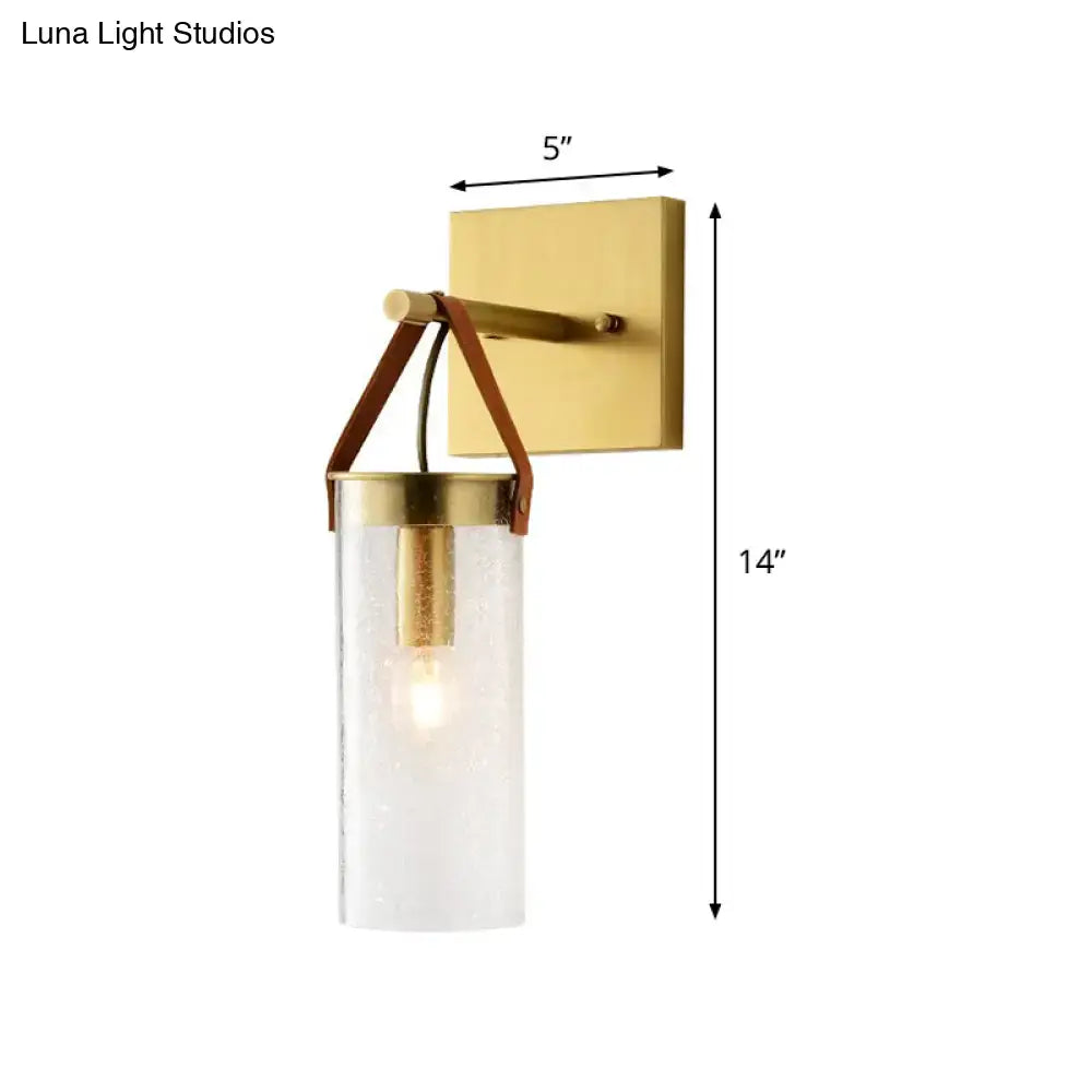 Postmodern brass wall sconce with gold finish clear crack glass cylinder and leather strap accents for dining room lighting