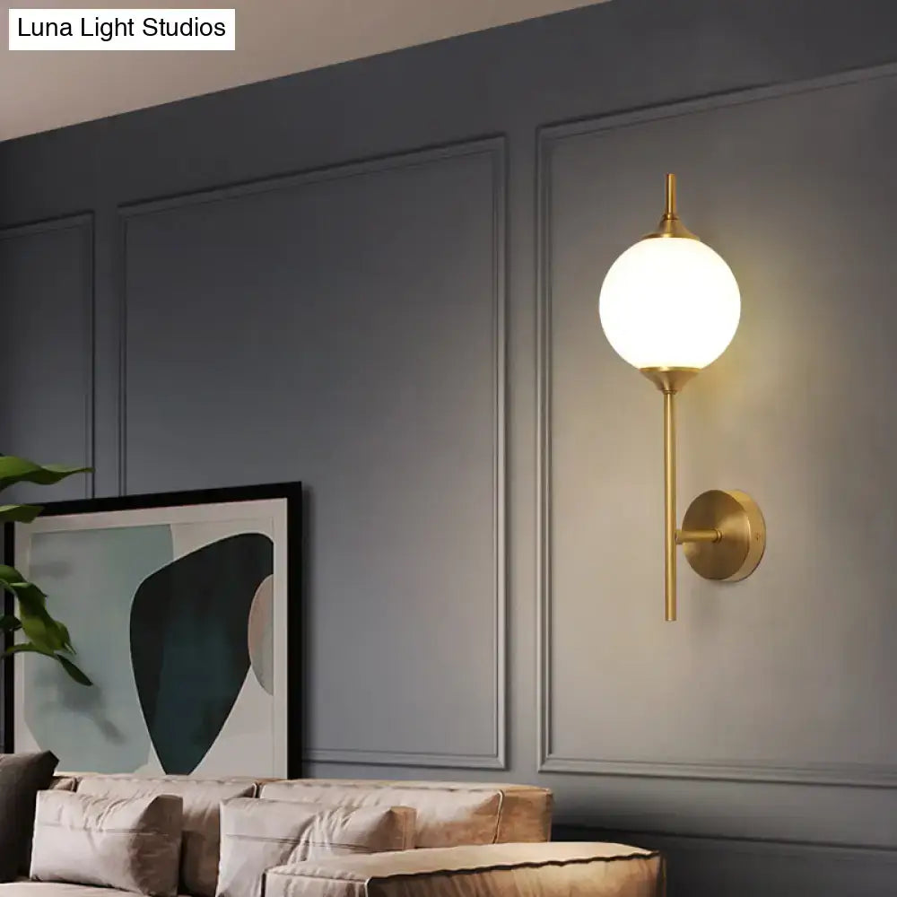 Postmodern gold-toned wall sconce with white glass geometric spherical frosted globe for living room lighting