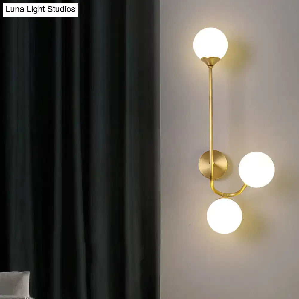 Postmodern brass wall sconce with white glass geometric shades in a branching design for living room use