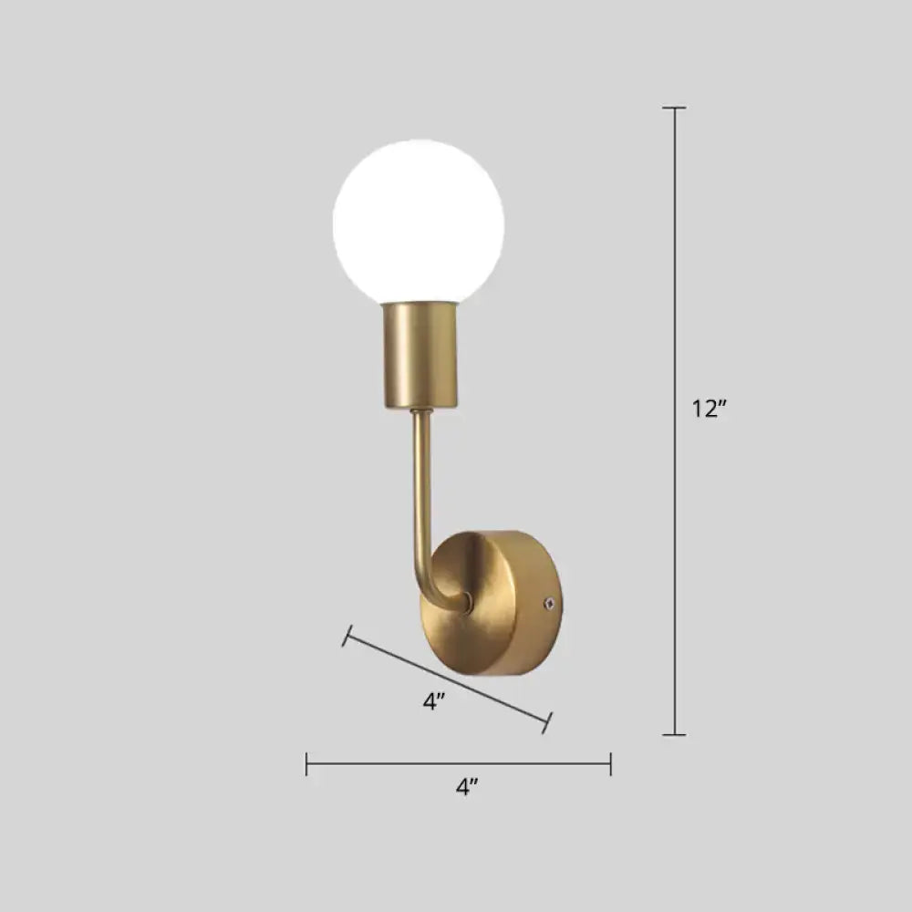 A sleek postmodern brass wall sconce with a white glass geometric frosted bulb and minimalist curved arm for living room