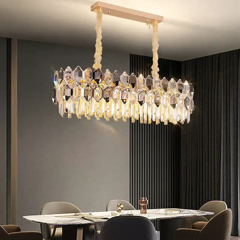 A modern decorbites crystal chandelier with a rose gold frame and cascading clear and amber prisms for living room