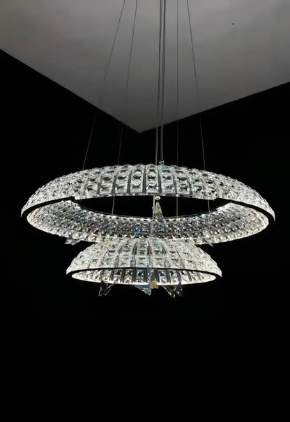 A modern multi-tiered chrome pendant light with cascading faceted glass in decorbites crystal butterfly style