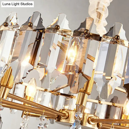 Gold-toned DecorBites™ postmodern crystal chandelier with faceted prisms and clear loop shade for living room use
