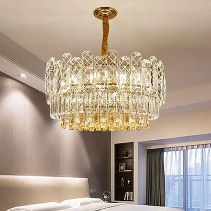 A luxurious decorbites gold lustre chandelier with gold tones and crystal prisms for dining room lighting