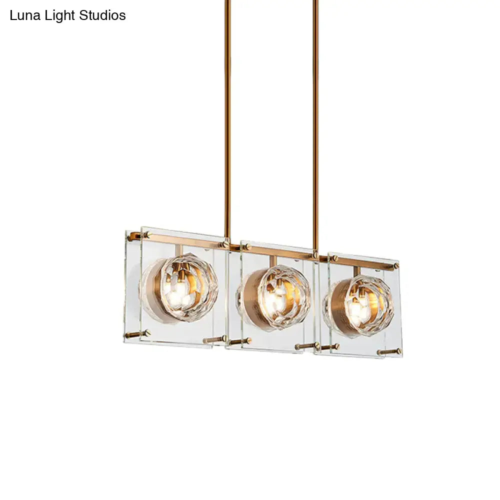 Postmodern gold and clear glass kitchen island light with three crystal-encased bulbs for modern island lighting