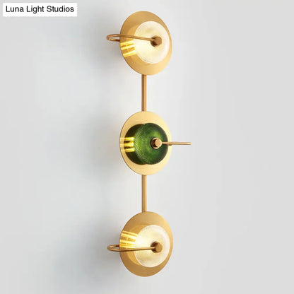 Postmodern gold wall sconce with three glass disc shades includes central olive textured and frosted clear lamps