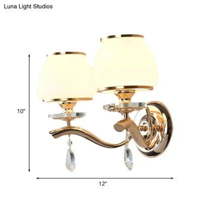 Postmodern gold wall sconce with direct wired crystal drop and white glass shades for bedroom lighting
