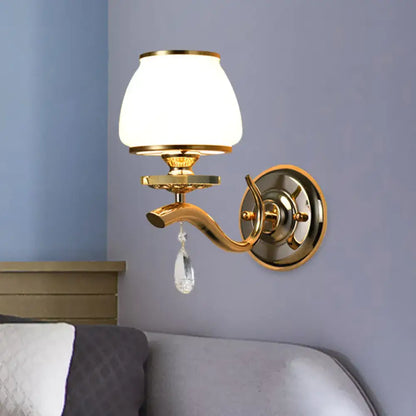 Postmodern gold wall sconce with white glass shade and crystal drop direct wired for bedroom lighting