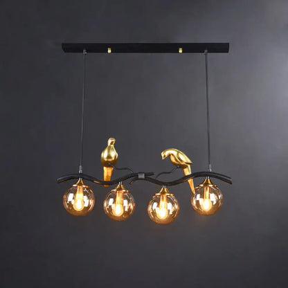 Gold-colored bird deco pendant light with amber glass globes and black metal branch for 110v-120v or 220v-240v use