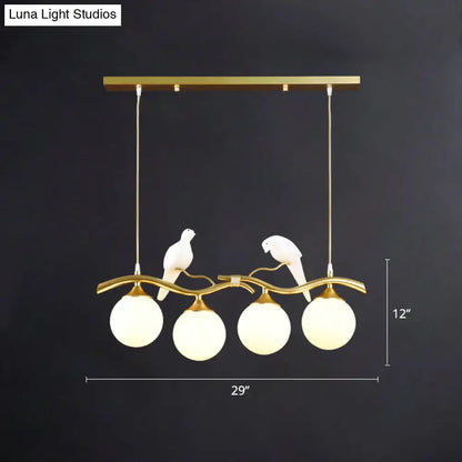 Gold-toned DecorBites™ sleek postmodern glass pendant light with bird deco and frosted globes 110v-120v 220v-240v compatible