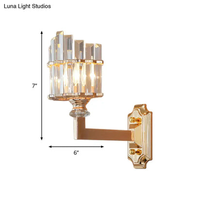 Postmodern gold crystal rod wall light featuring a gold-finished single wall light with clear faceted crystal columns